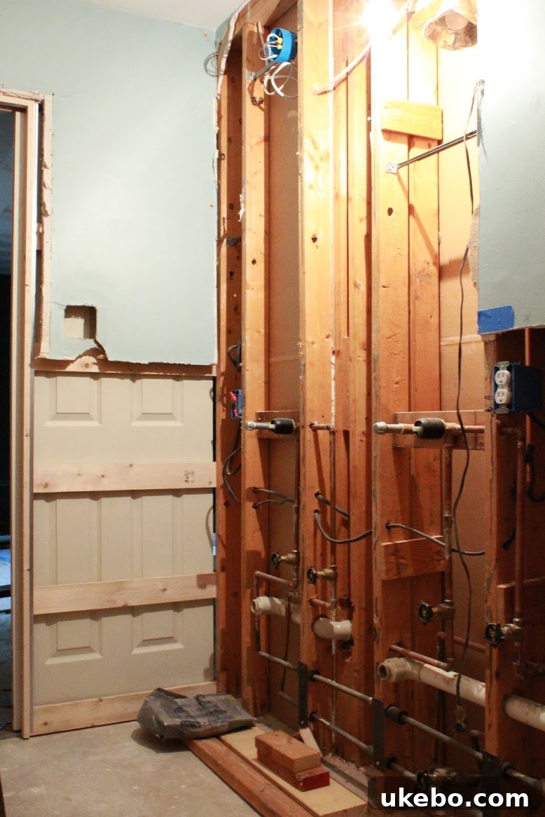 Bathroom plumbing and electrical work in progress during renovation.