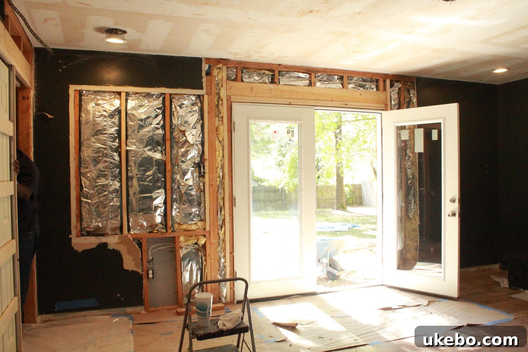 Interior view of master bedroom with newly installed French doors, bringing in abundant light.