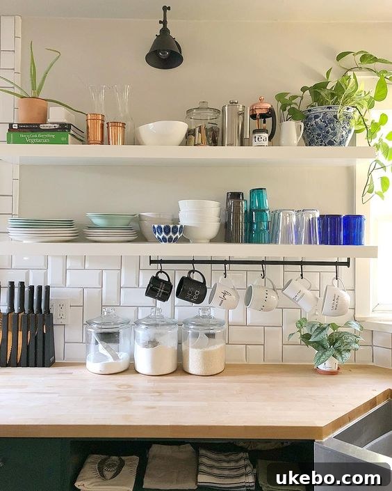 KUNGSFORS rail in a modern kitchen, holding pots and pans for easy access and space-saving.