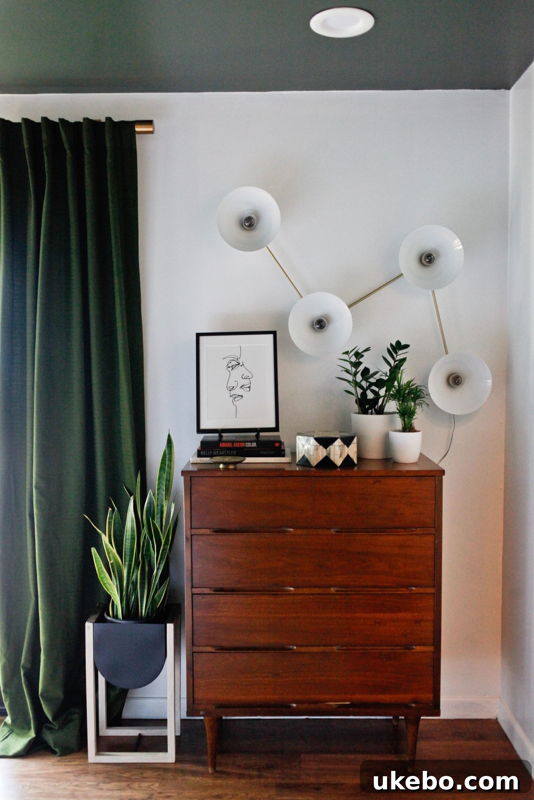 Detailed shot of the master bedroom's art arrangement and the textured Loloi rug