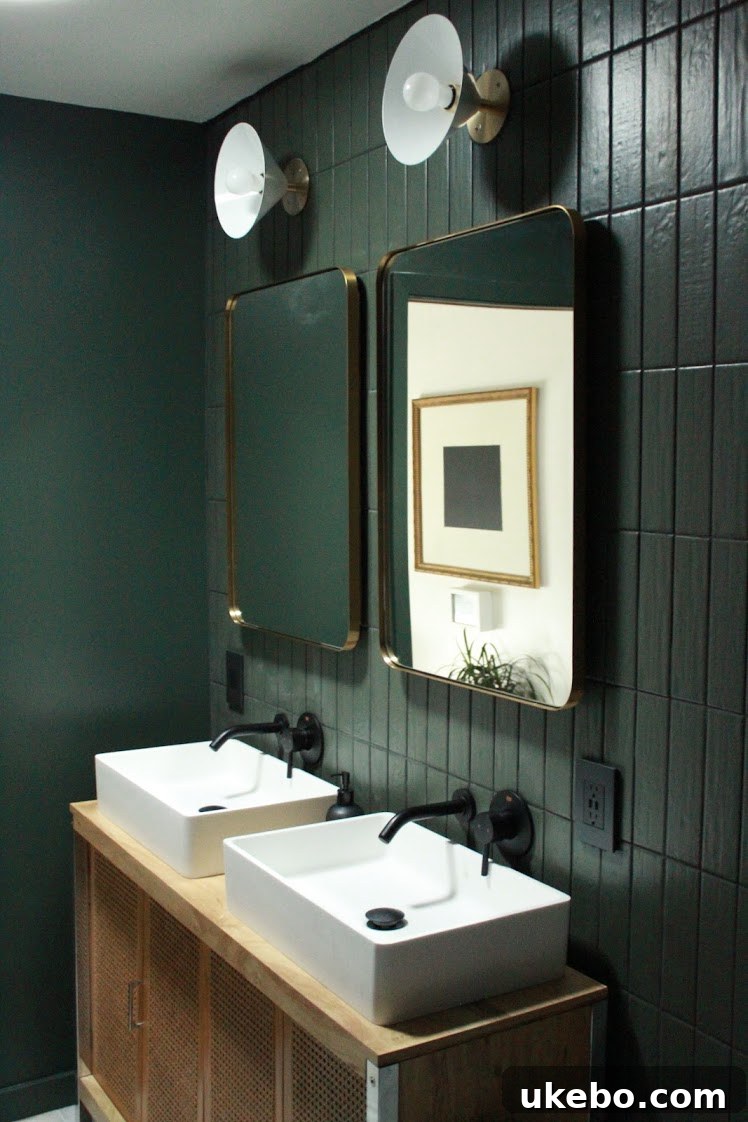 Close-up of the vintage cane vanity contrasting beautifully against moody green tiles