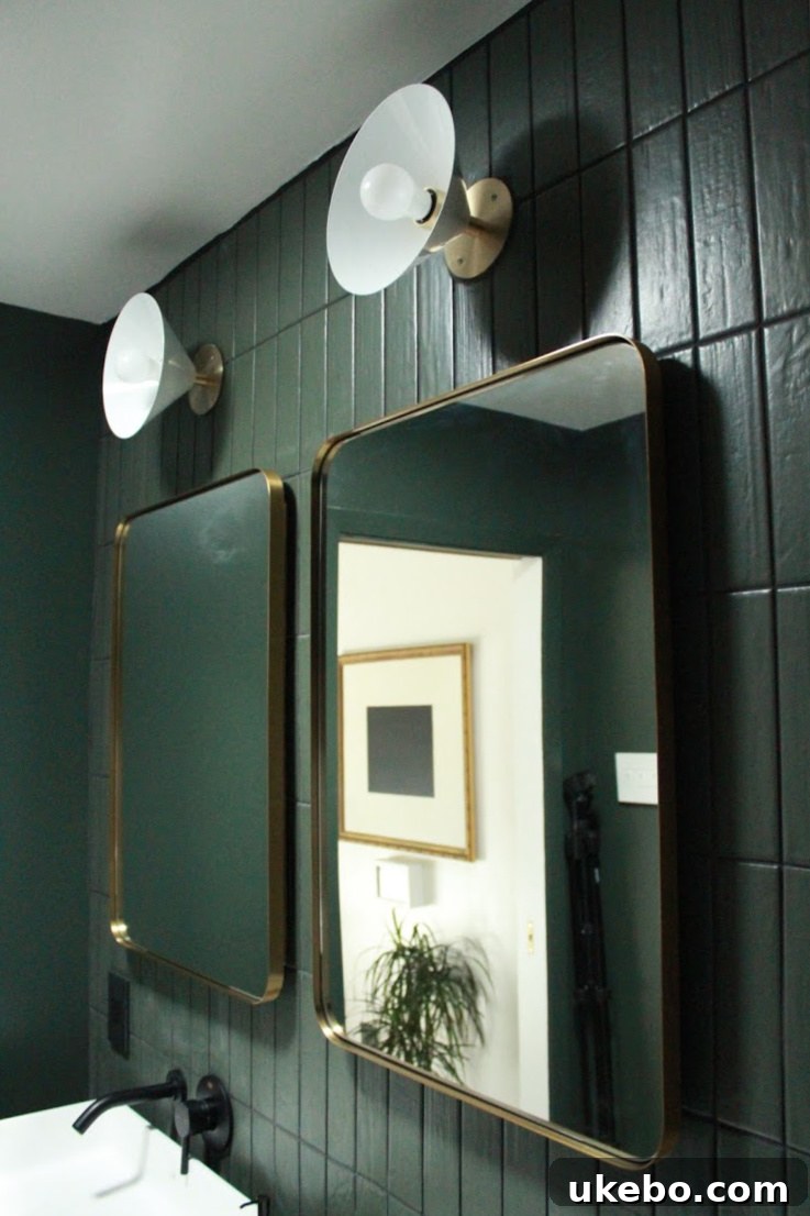 Focal Point Wall Sconces from Blueprint Lighting flanking vanity mirrors in the bathroom