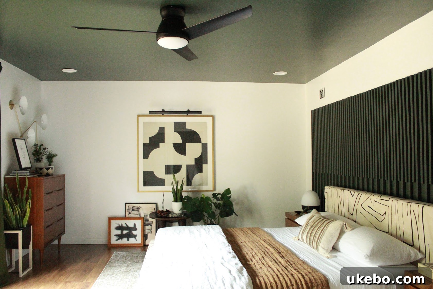 View of the newly designed master bedroom with a tranquil seating area and natural light