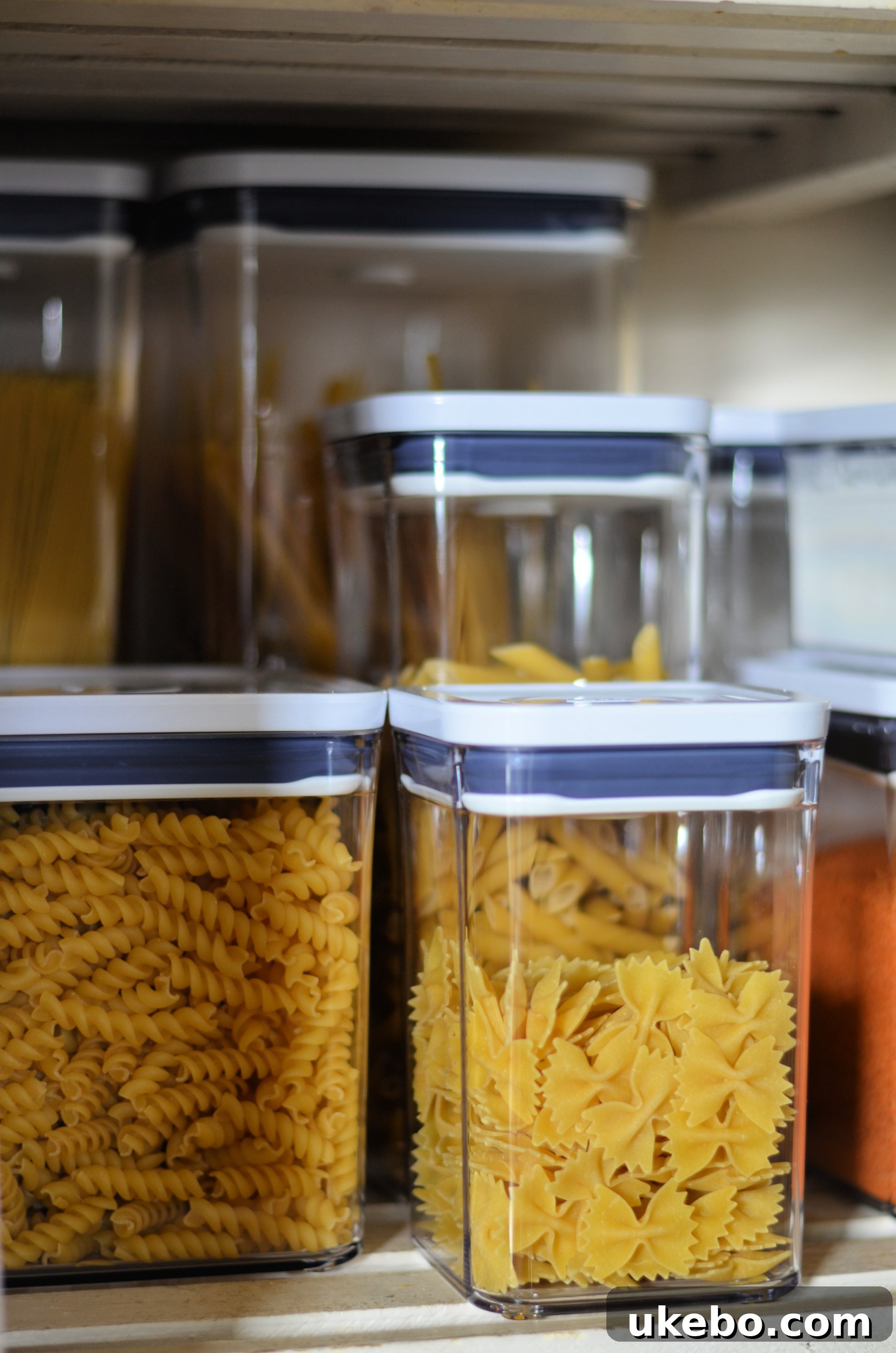 View of the newly organized pantry, showing a mix of OXO POP containers and other storage solutions