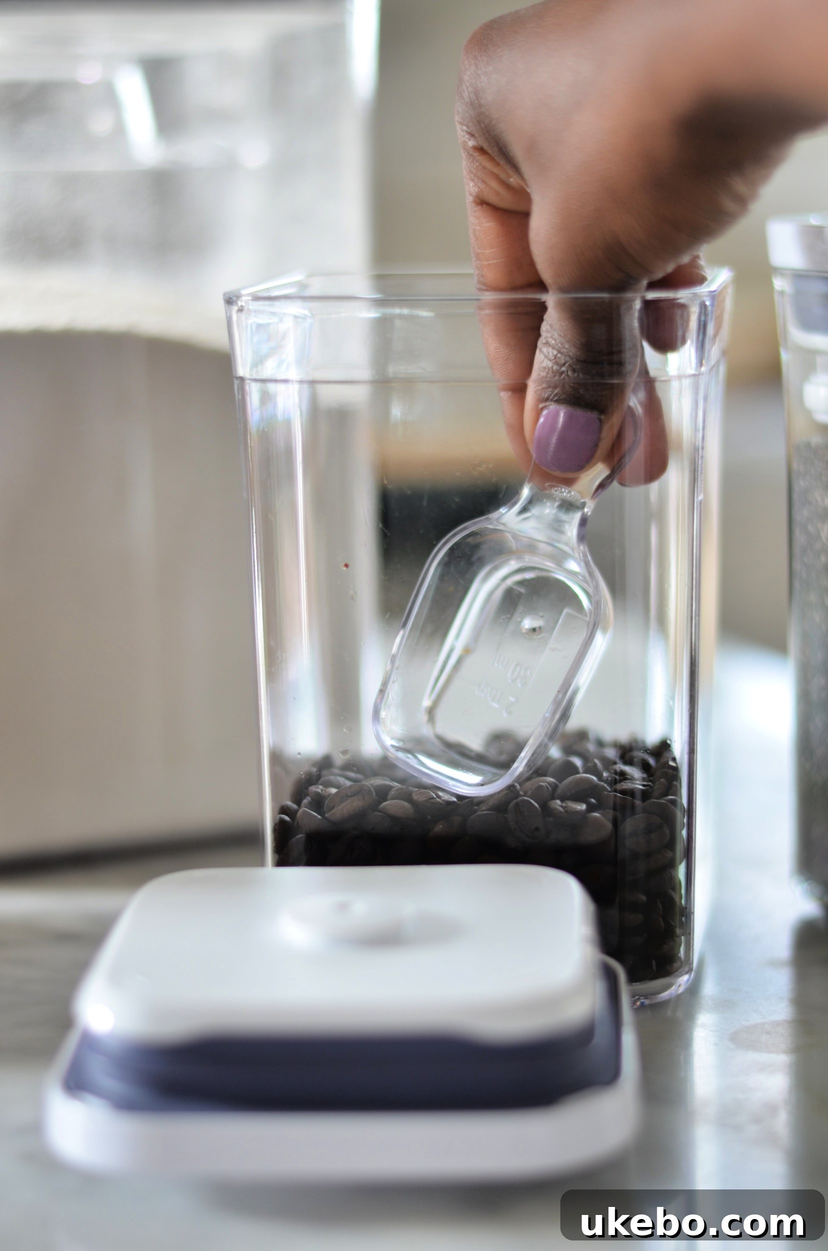 Close-up of an OXO POP container with an attached scoop inside the lid