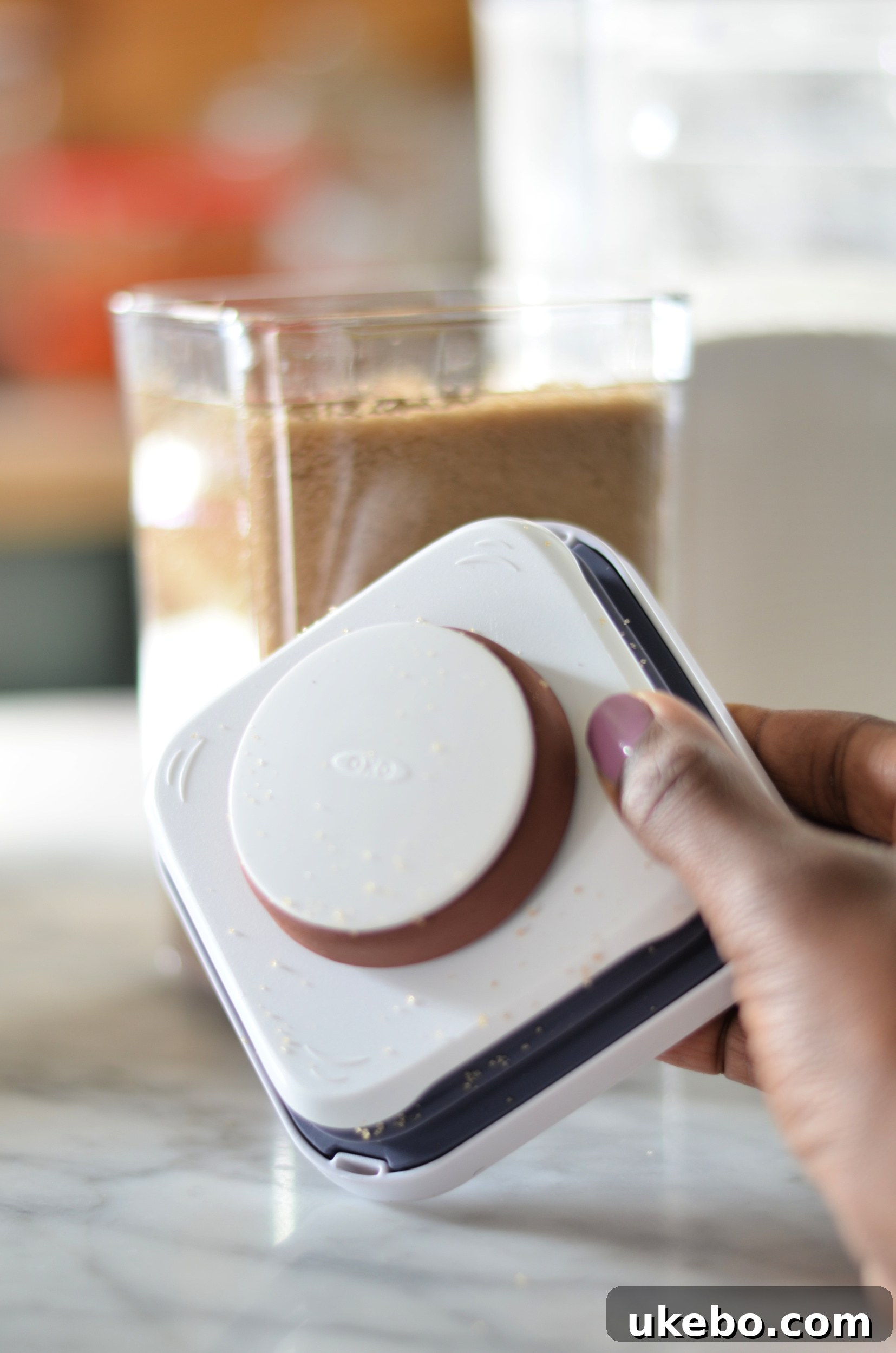 OXO POP container with a brown sugar saver attached to the lid, keeping sugar soft