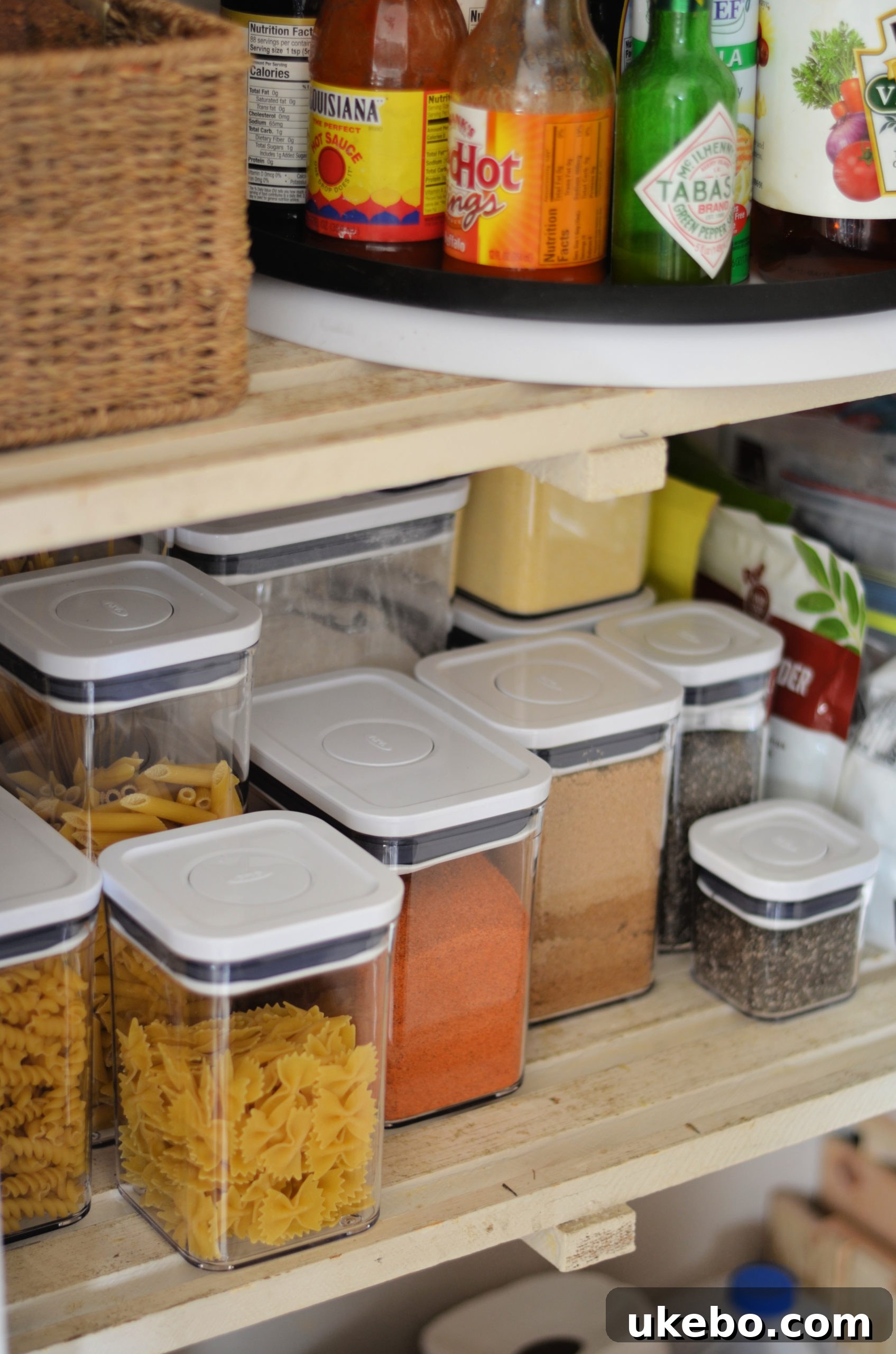 Close-up of organized OXO POP containers in the pantry, showcasing variety of sizes and contents
