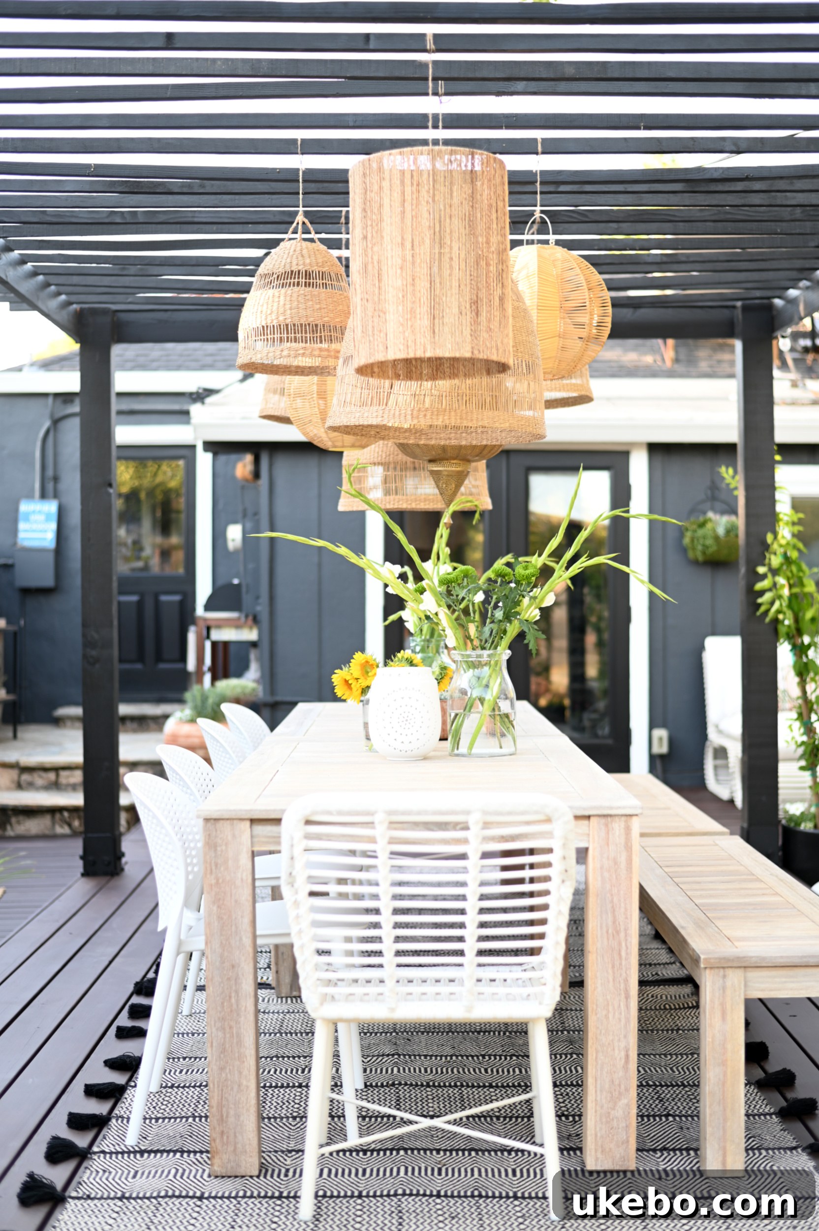 Outdoor dining area under a black pergola