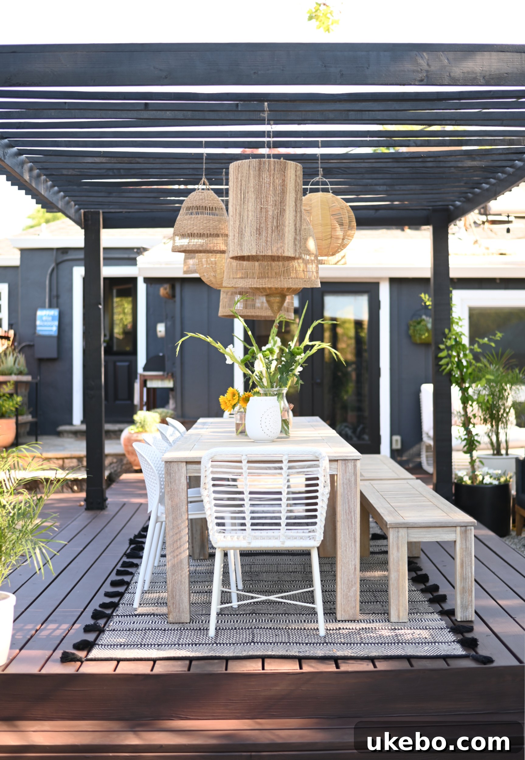 Revealed backyard with dark stained deck and lounge area