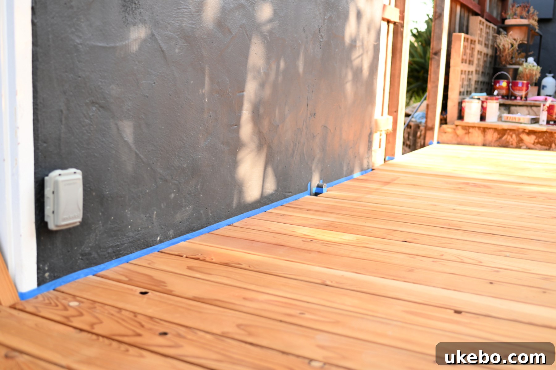 Bringing Our Deck Back to Life with Sherwin-Williams 13 Taping off the house perimeter before deck staining