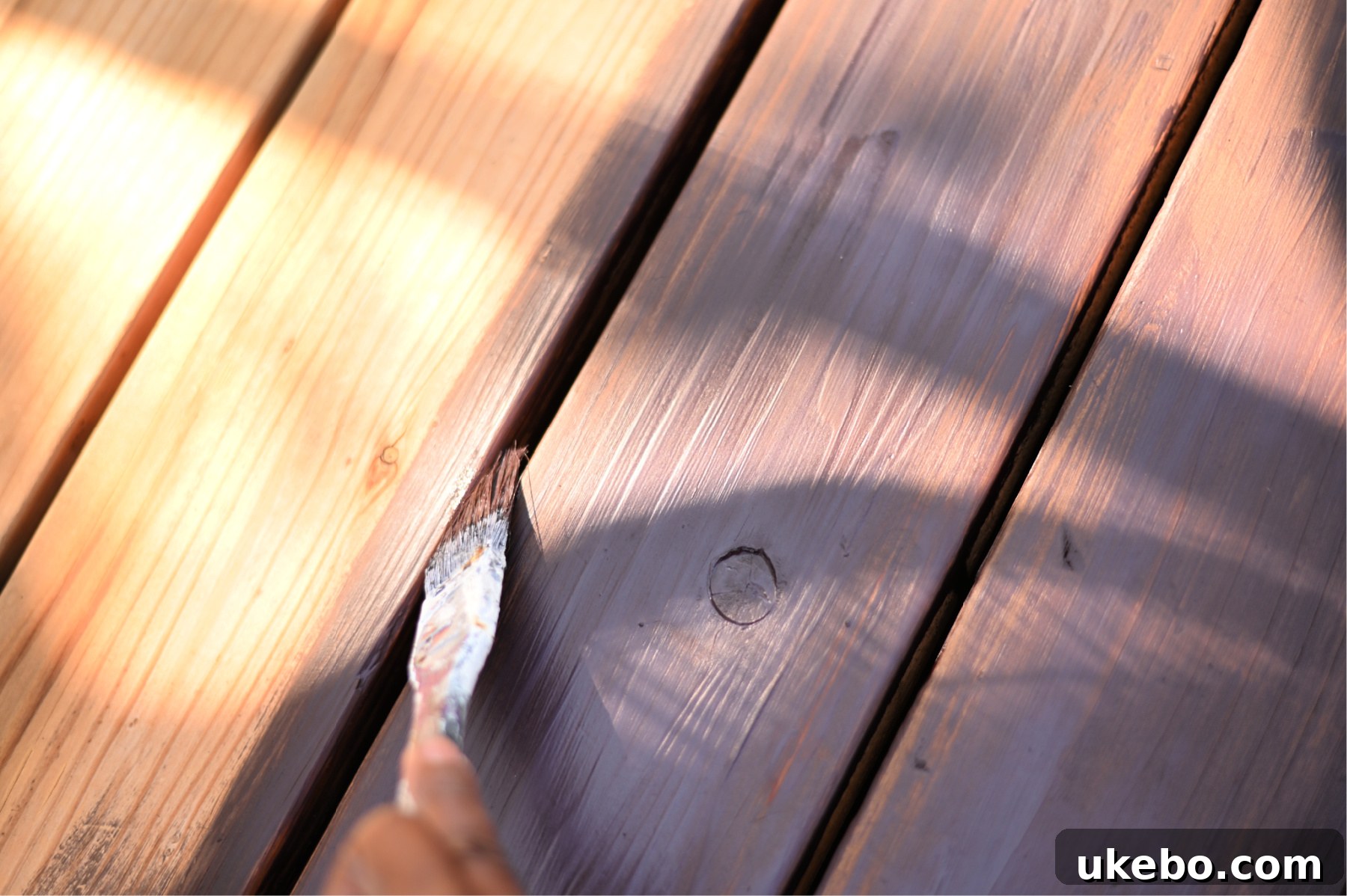 Bringing Our Deck Back to Life with Sherwin-Williams 21 Detail shot of staining between deck boards