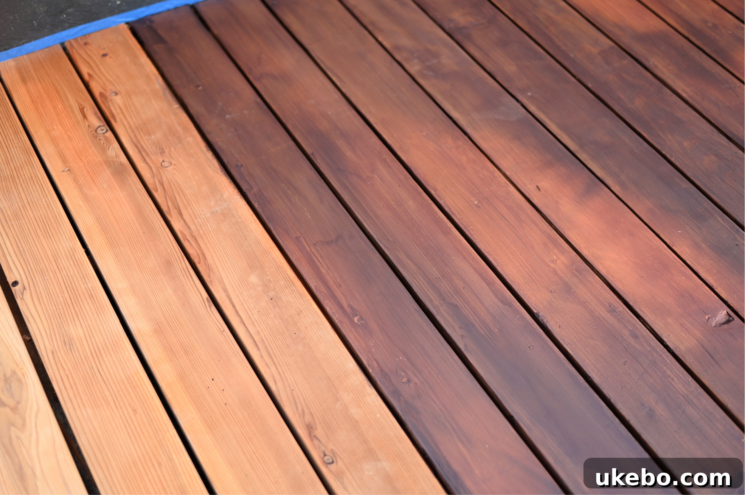 Progress shot of the stained deck after the first coat