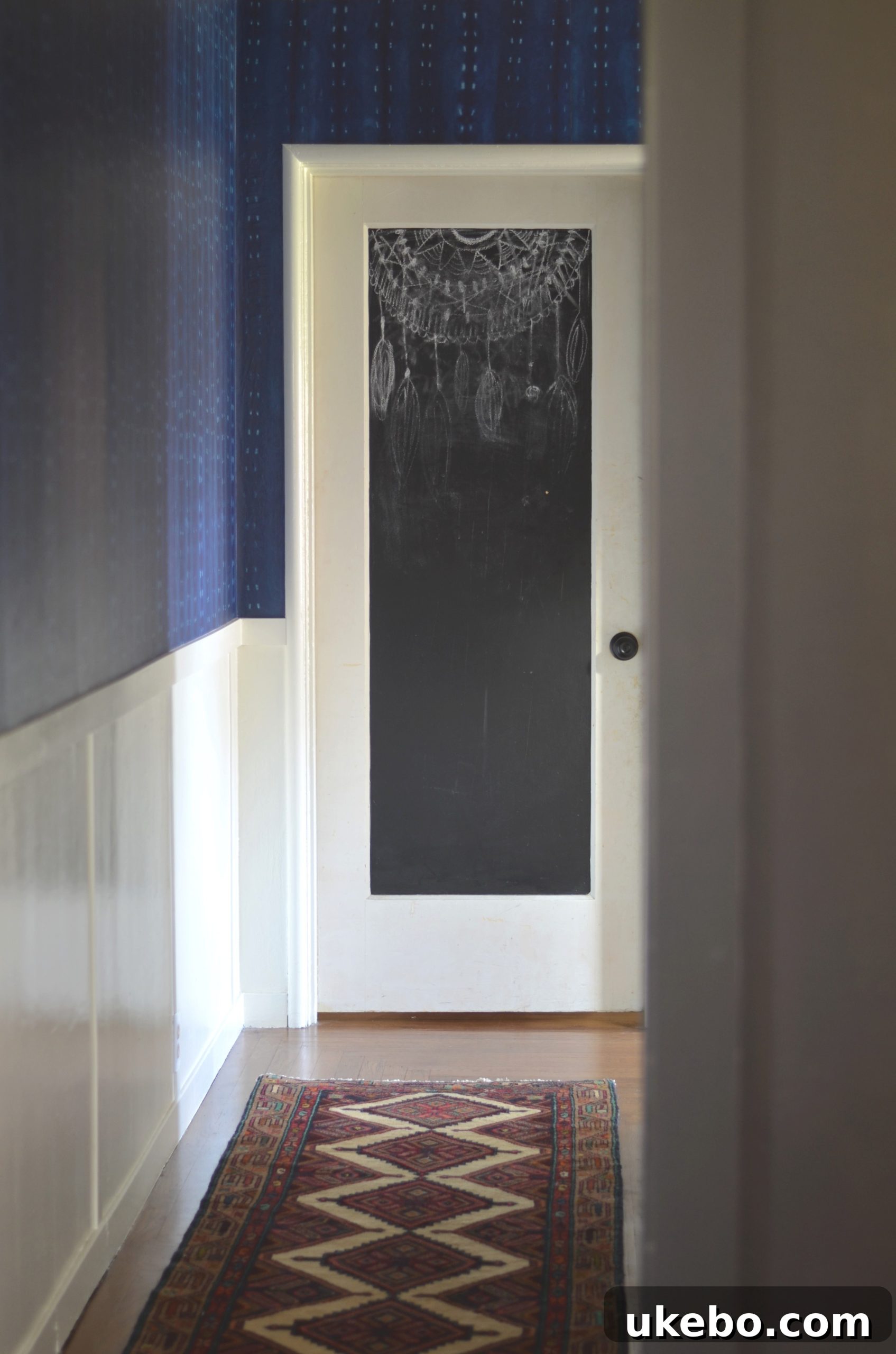 Refreshed hallway with vintage crystal chandeliers and new hardware on built-ins.