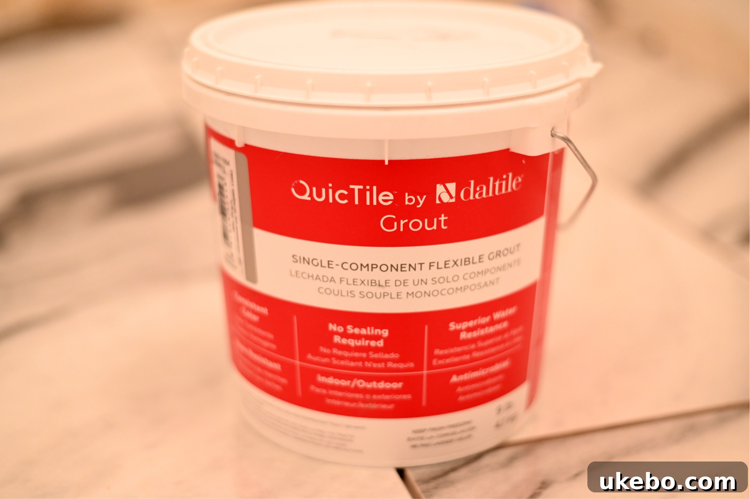 A close-up image showing the application of premixed grout on the newly installed QuicTile floor.