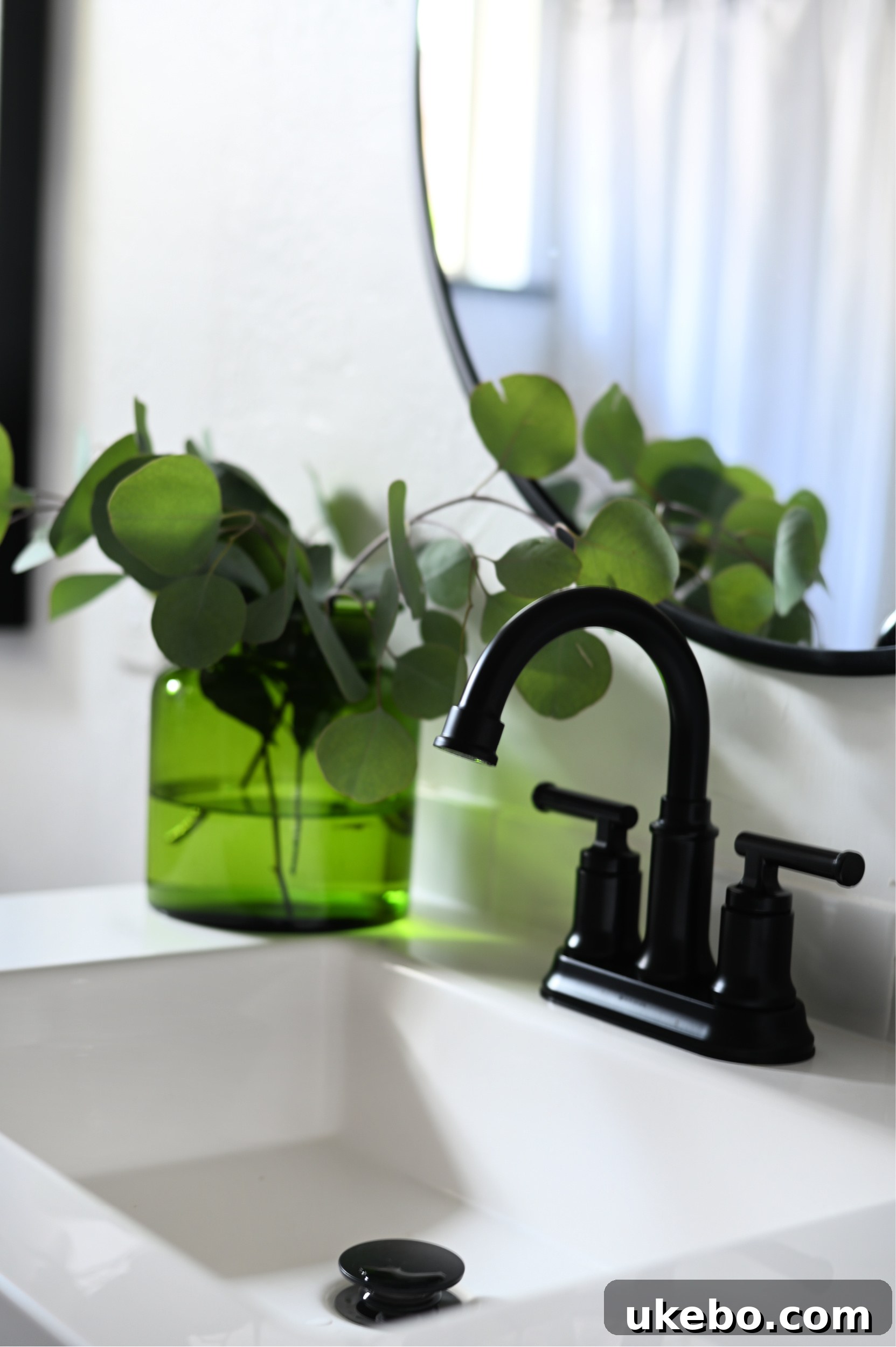 A wide shot of the refreshed bathroom, showcasing the completed QuicTile floor, black vanity, and new decor elements.