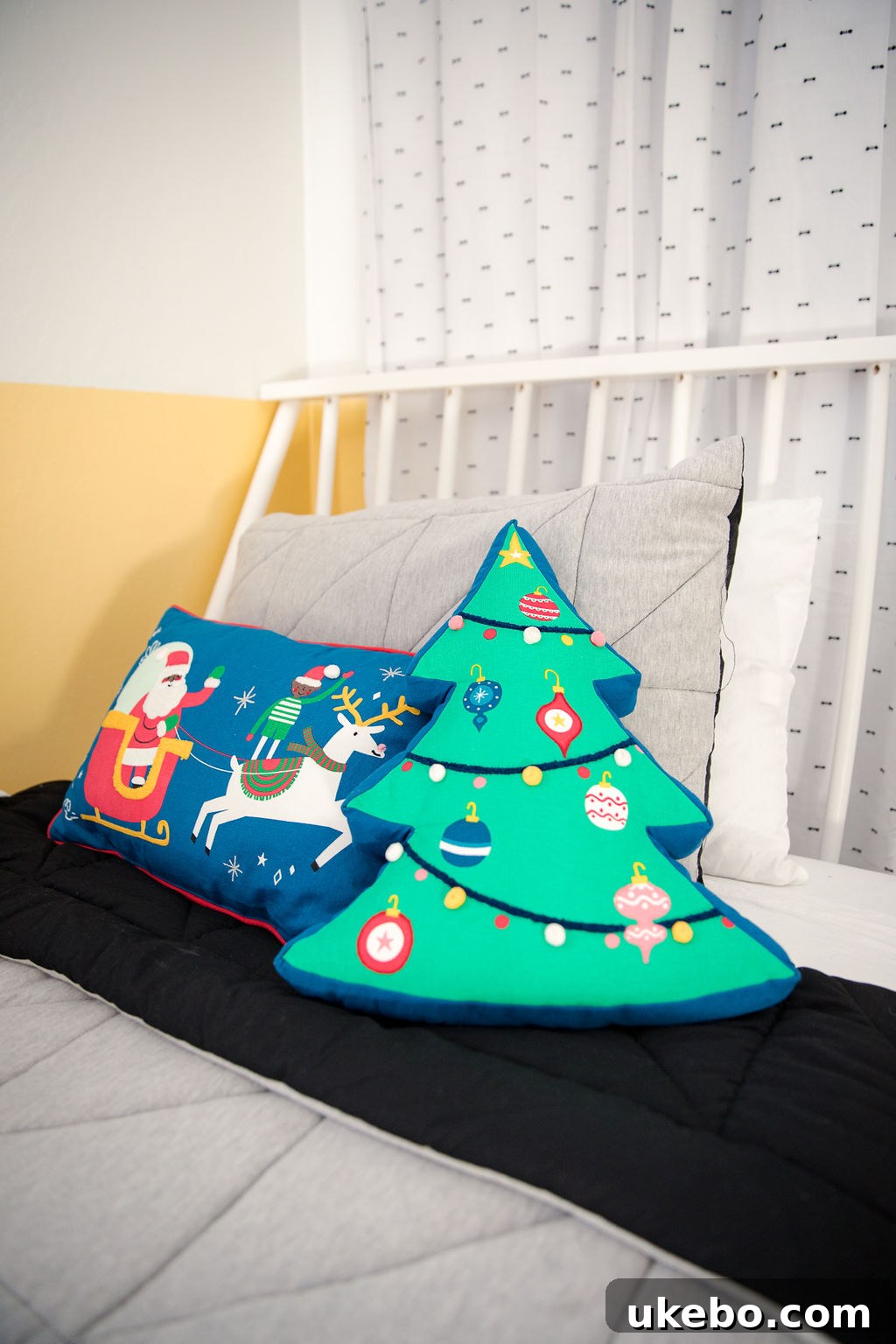Festive details: Christmas garland and playful decor accents in the redesigned twins' bedroom, adding whimsical charm.