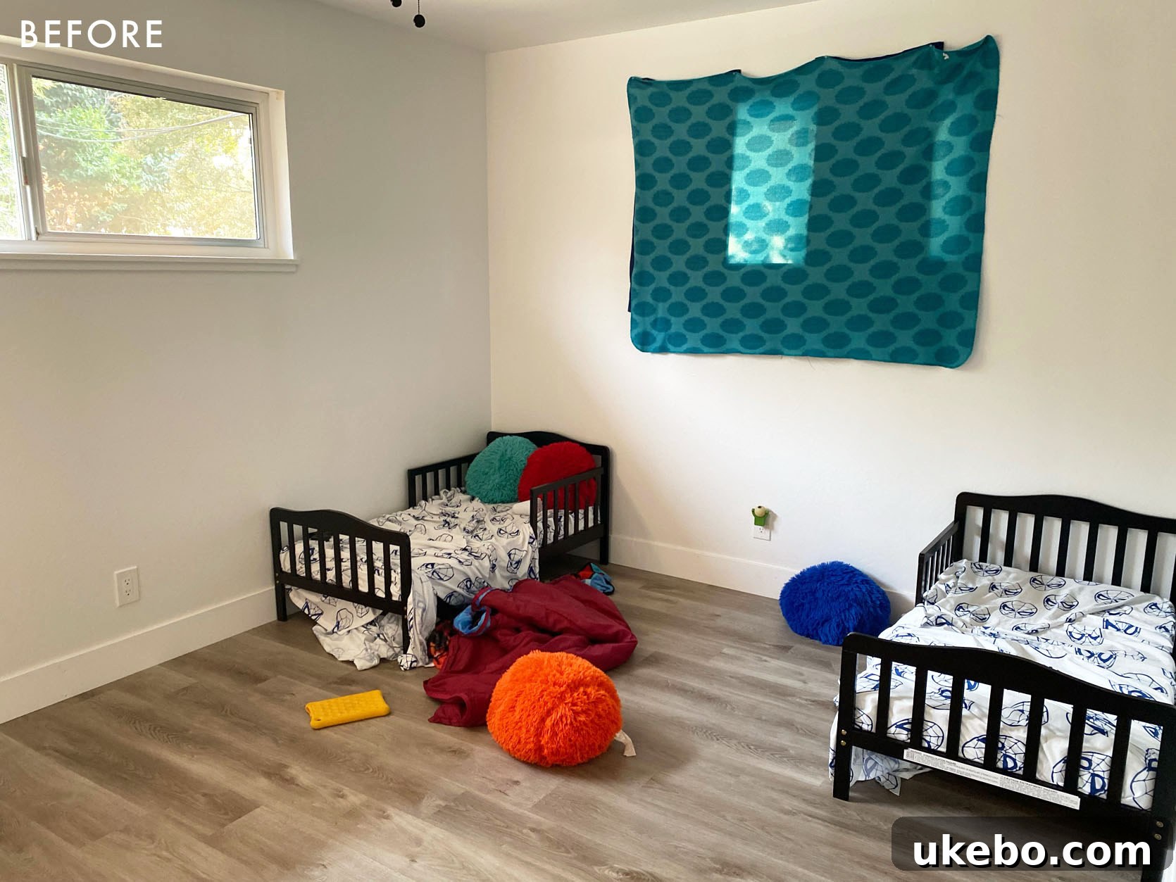 Before photo of twins' room: Empty and uninspired bedroom, a true blank slate awaiting a children's room design.