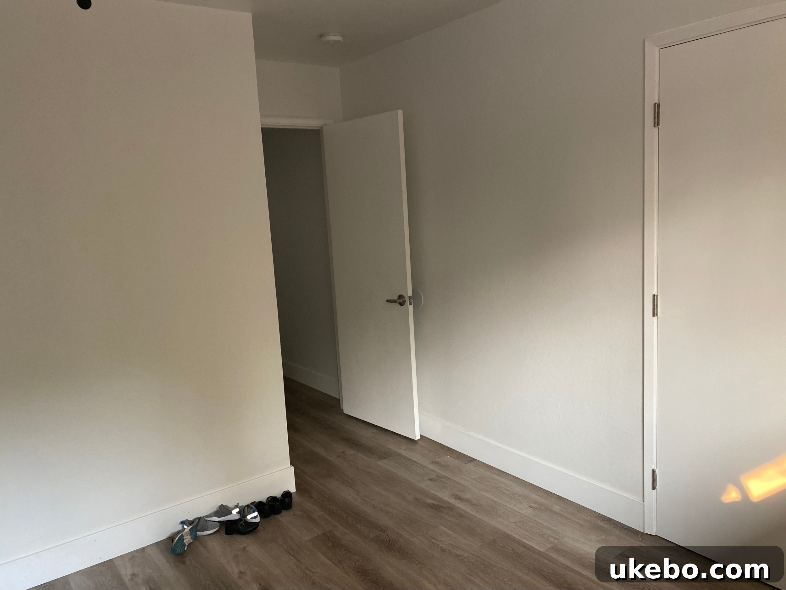 Another 'before' view of the twins' bedroom, highlighting its basic, undecorated state and bare walls.