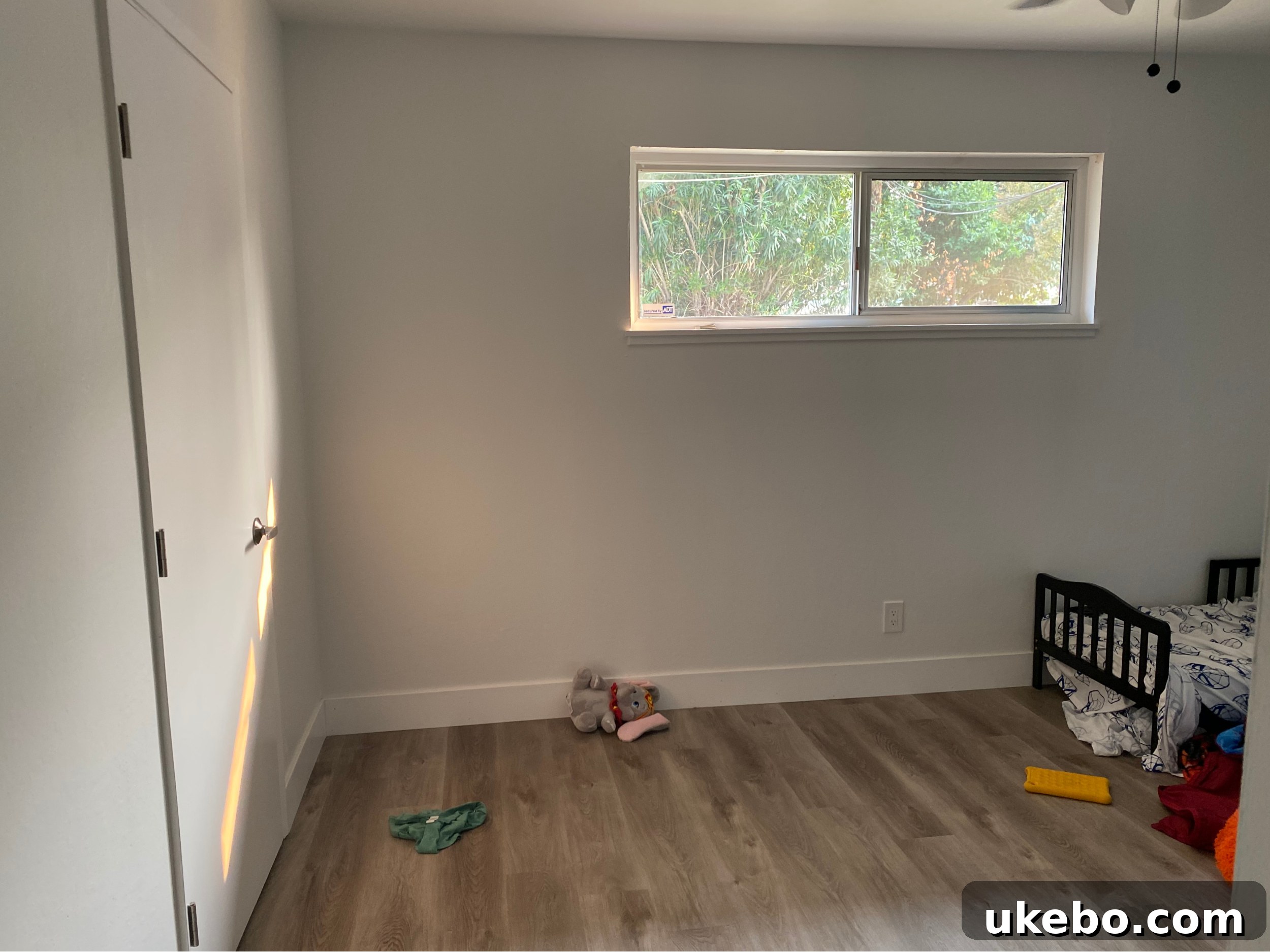 The original twins' room showing empty walls and floors, ready for a complete transformation and a new theme.
