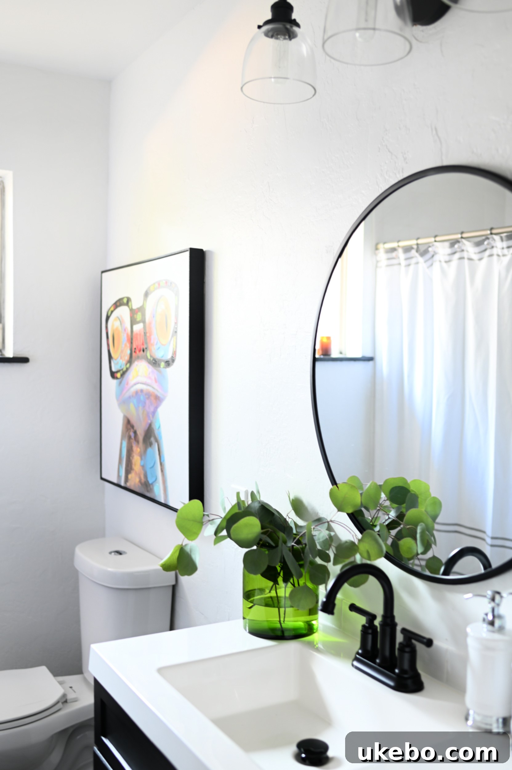 Close-up of a modern bathroom vanity with black accents against light blue walls, painted with Sherwin-Williams SuperPaint Air Purifying Technology.