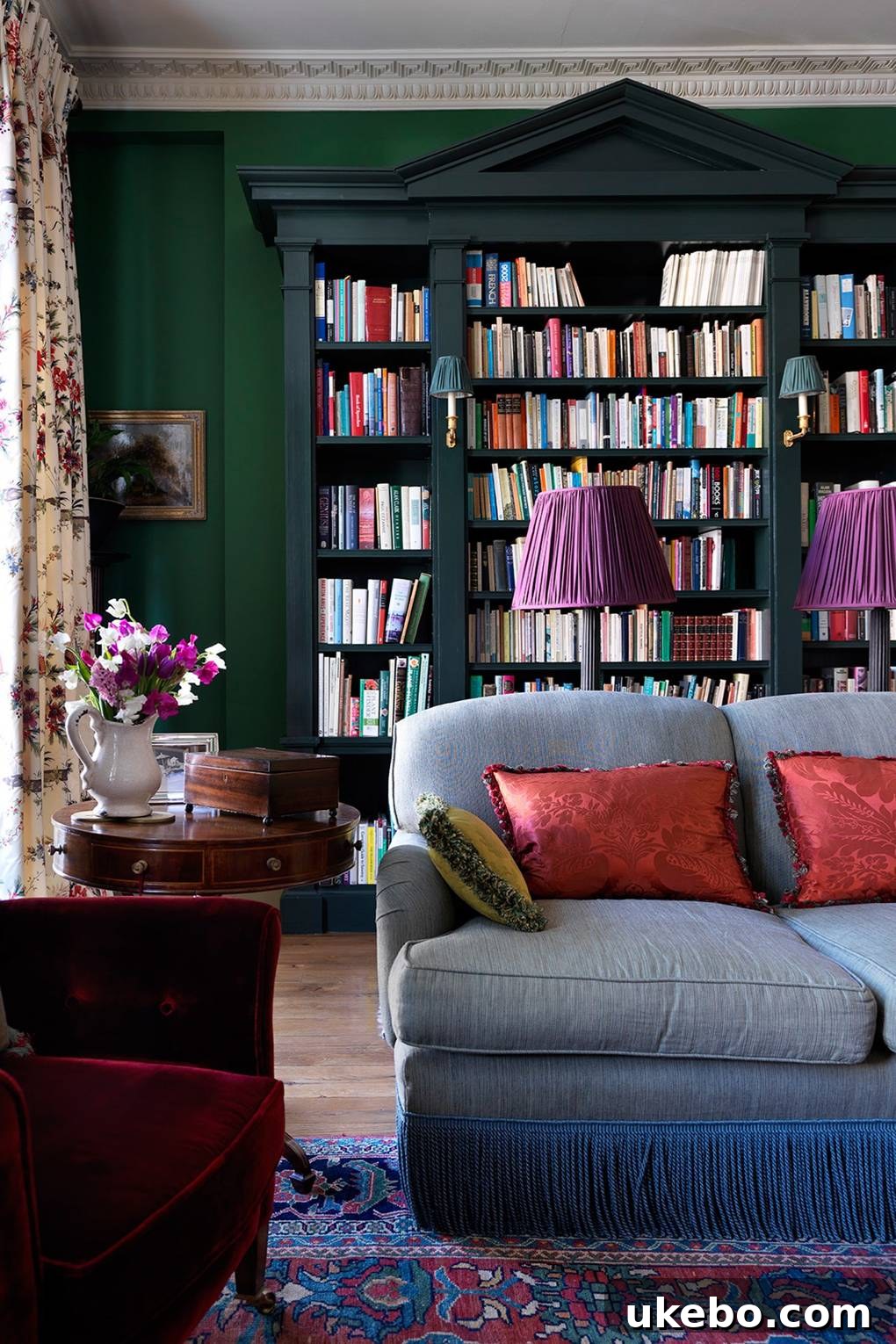 Interior with emerald green walls and contrasting art and furnishings