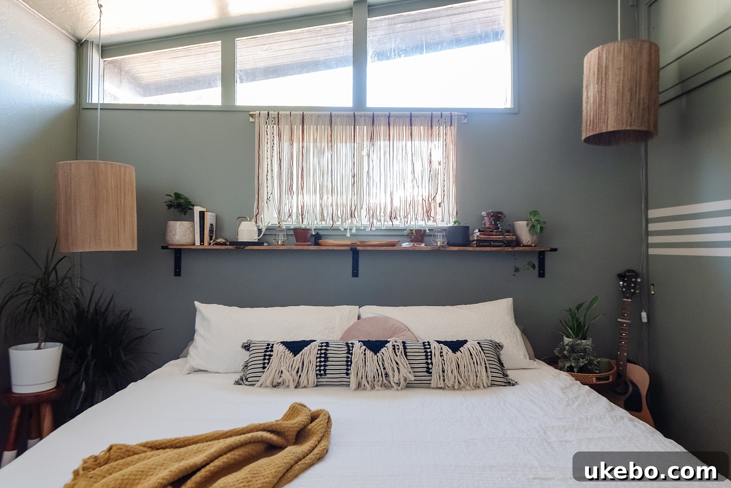 Detailed view of the primary bedroom's styling after the makeover, with carefully chosen plants and textured bedding.