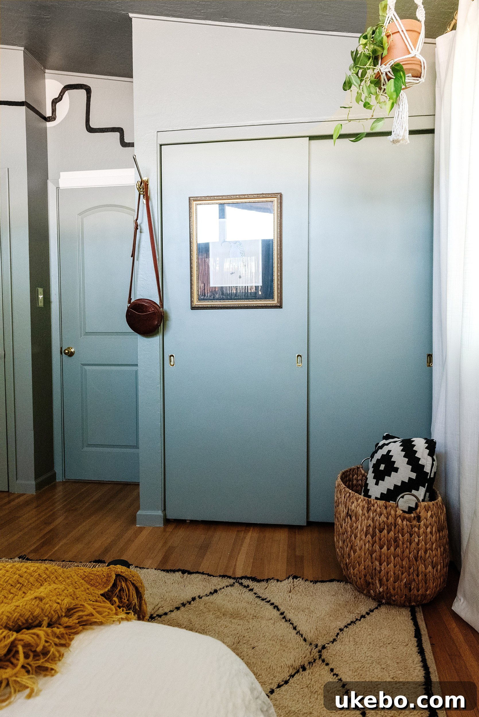 Another perspective of the bedside area, highlighting the simplicity and functionality of the shelf and the soothing green backdrop.