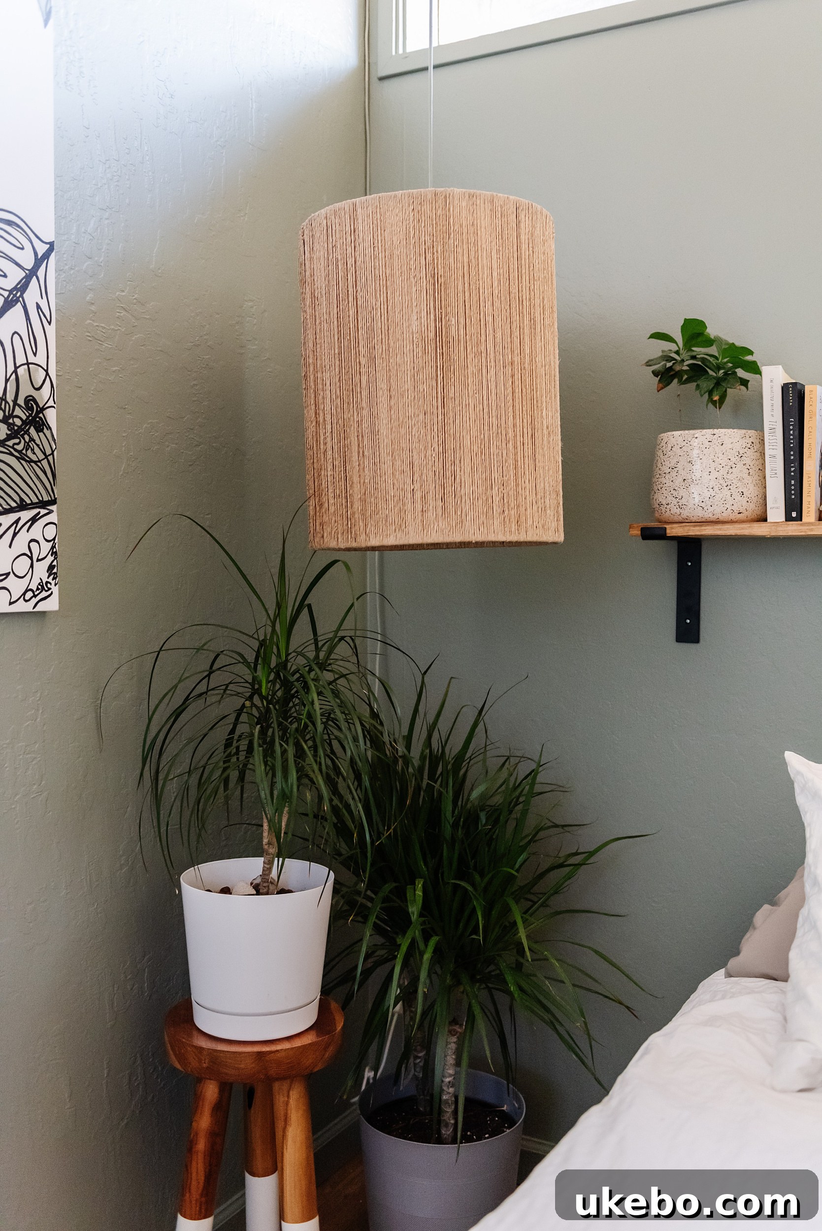 Close-up of artistic wall accents painted in Shoji White, Accessible Beige, and Tricorn Black against the Evergreen Fog wall.