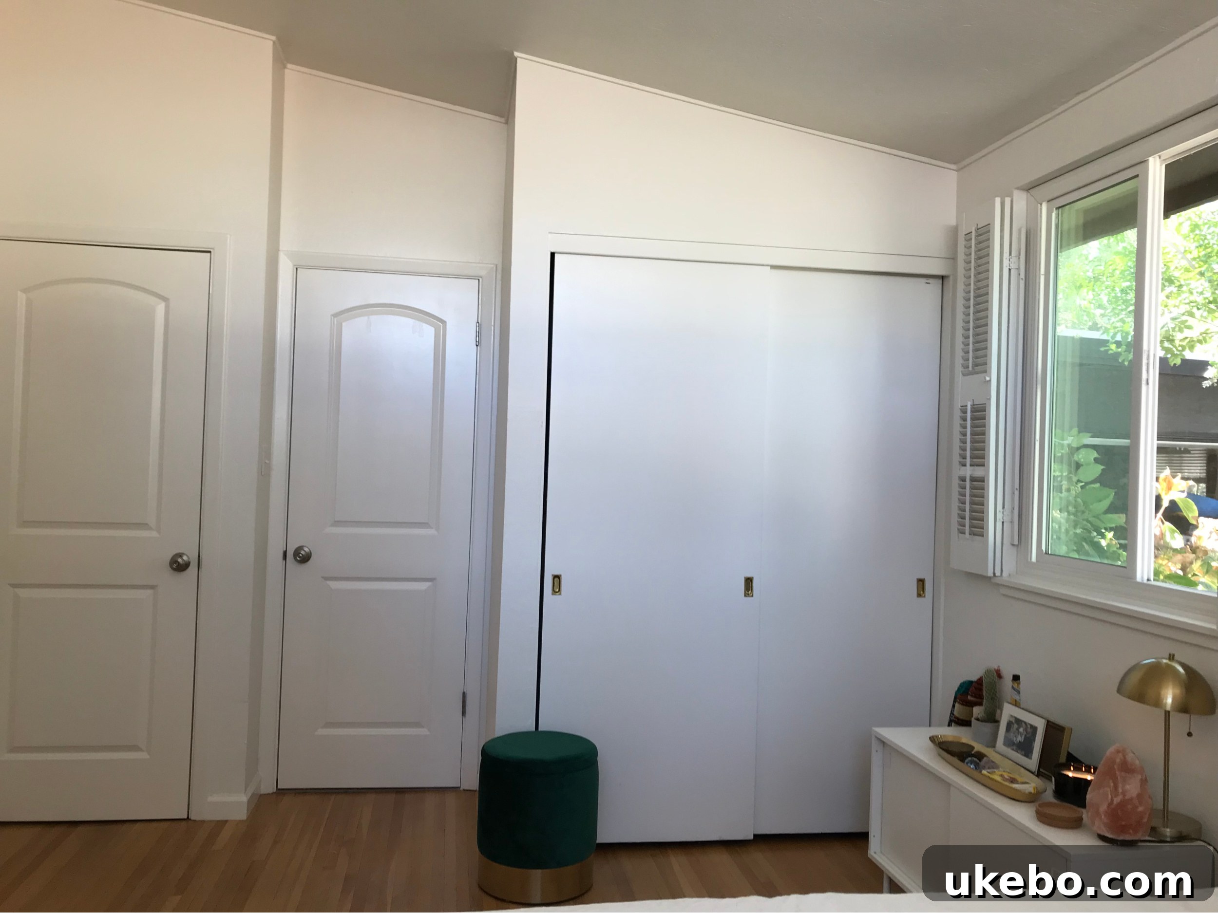 A wider view of the primary bedroom before the makeover, emphasizing its small footprint and need for clever storage solutions.