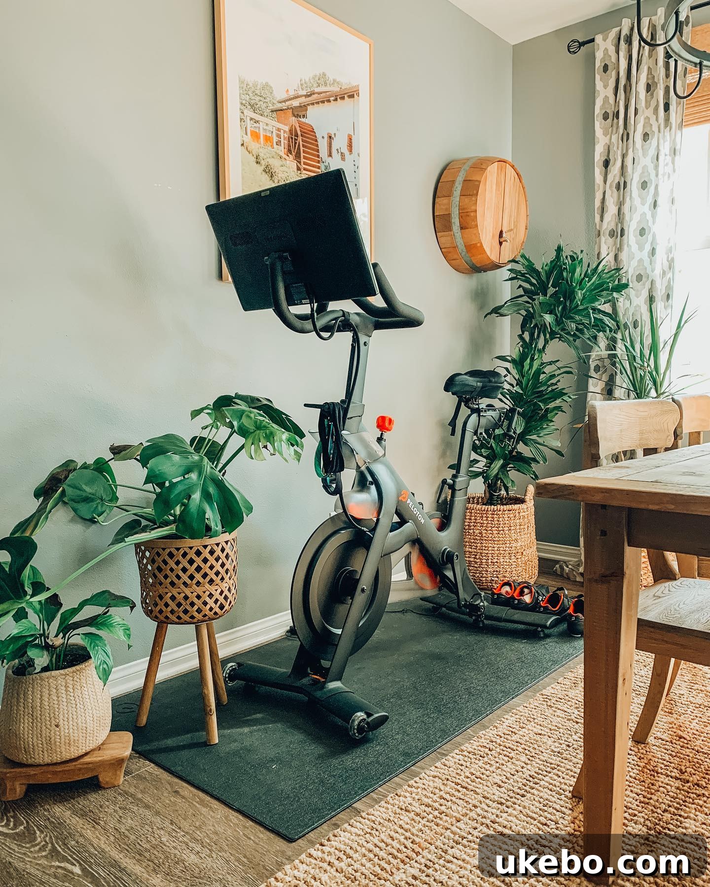 A stylish and modern Peloton bike set up in a bright, inviting home gym space.