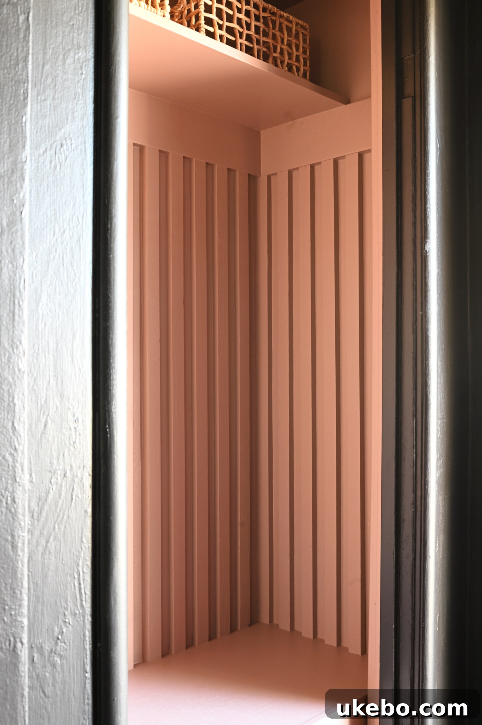 Entryway closet painted with Redend Point, showing bench and slats