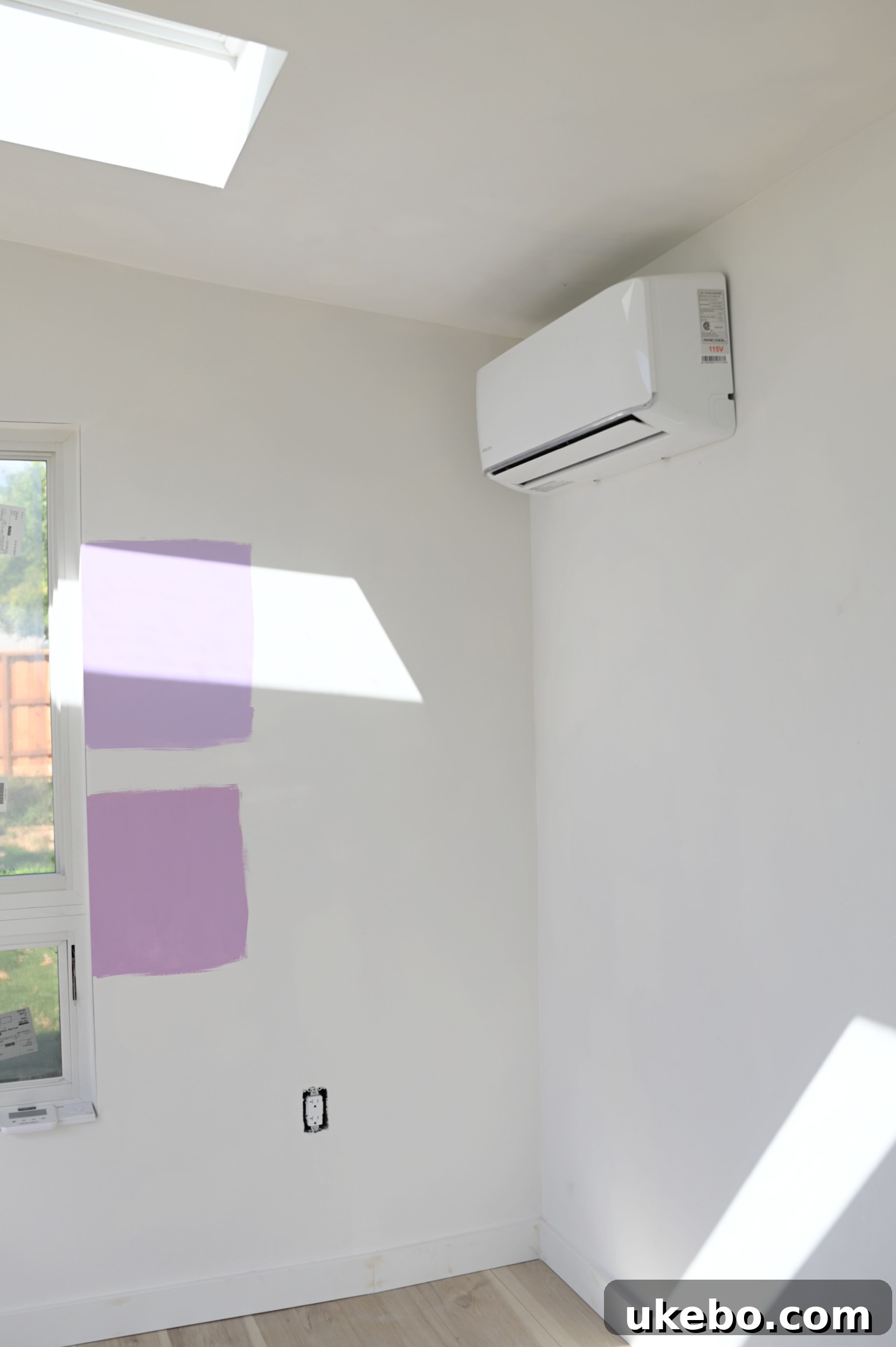 Detailed view of two purple paint samples, Magical and Novel Lilac, in natural light