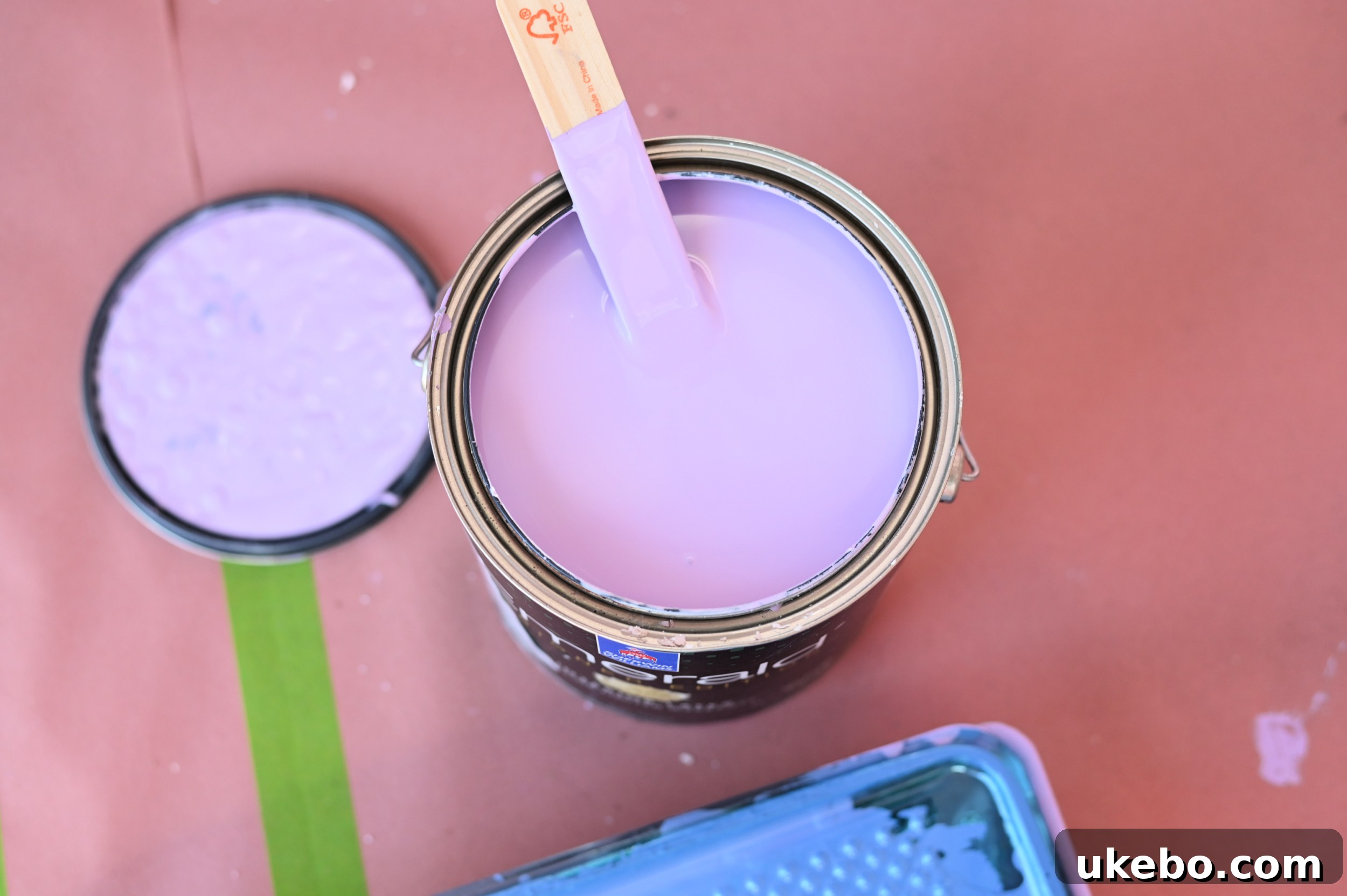 Painter applying Magical purple paint to the walls of the new office studio