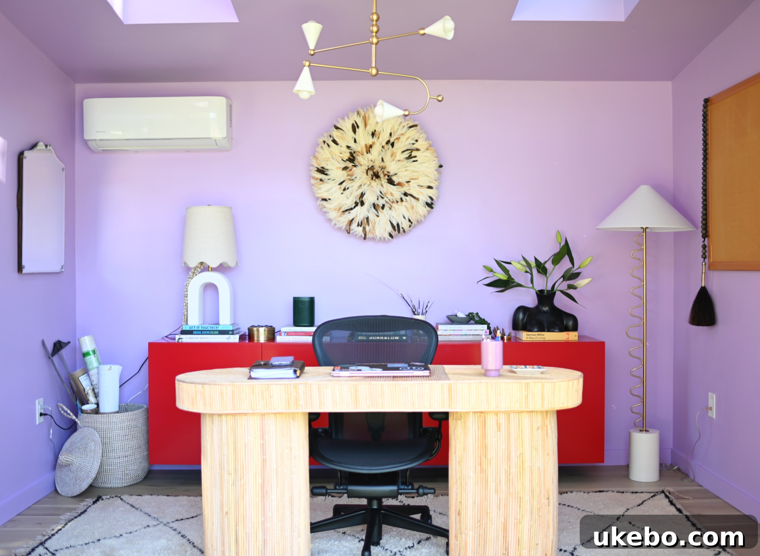 Thoughtfully arranged desk area in a vibrant purple and red office