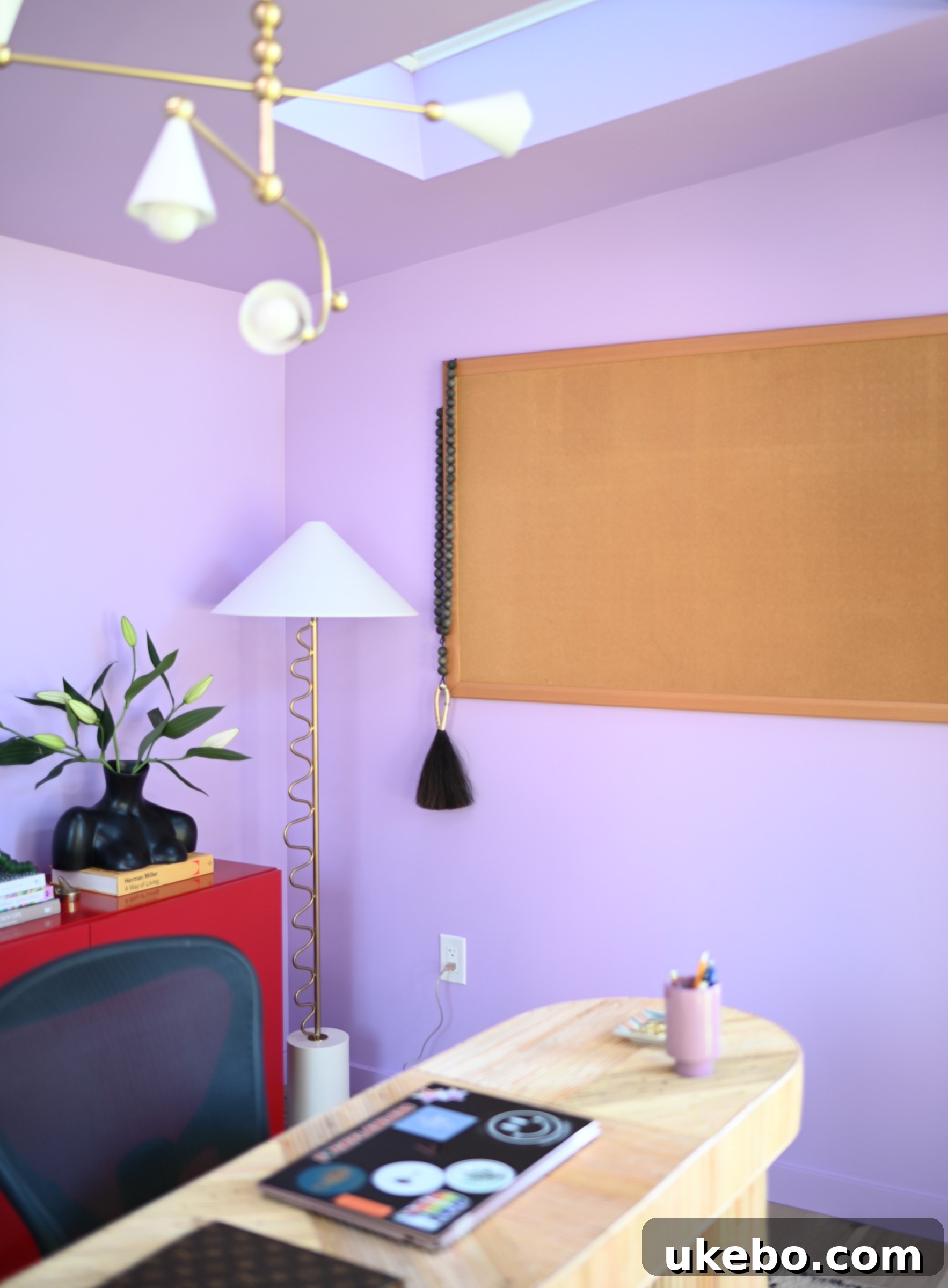 Artistic details and personal touches within the purple and red office space