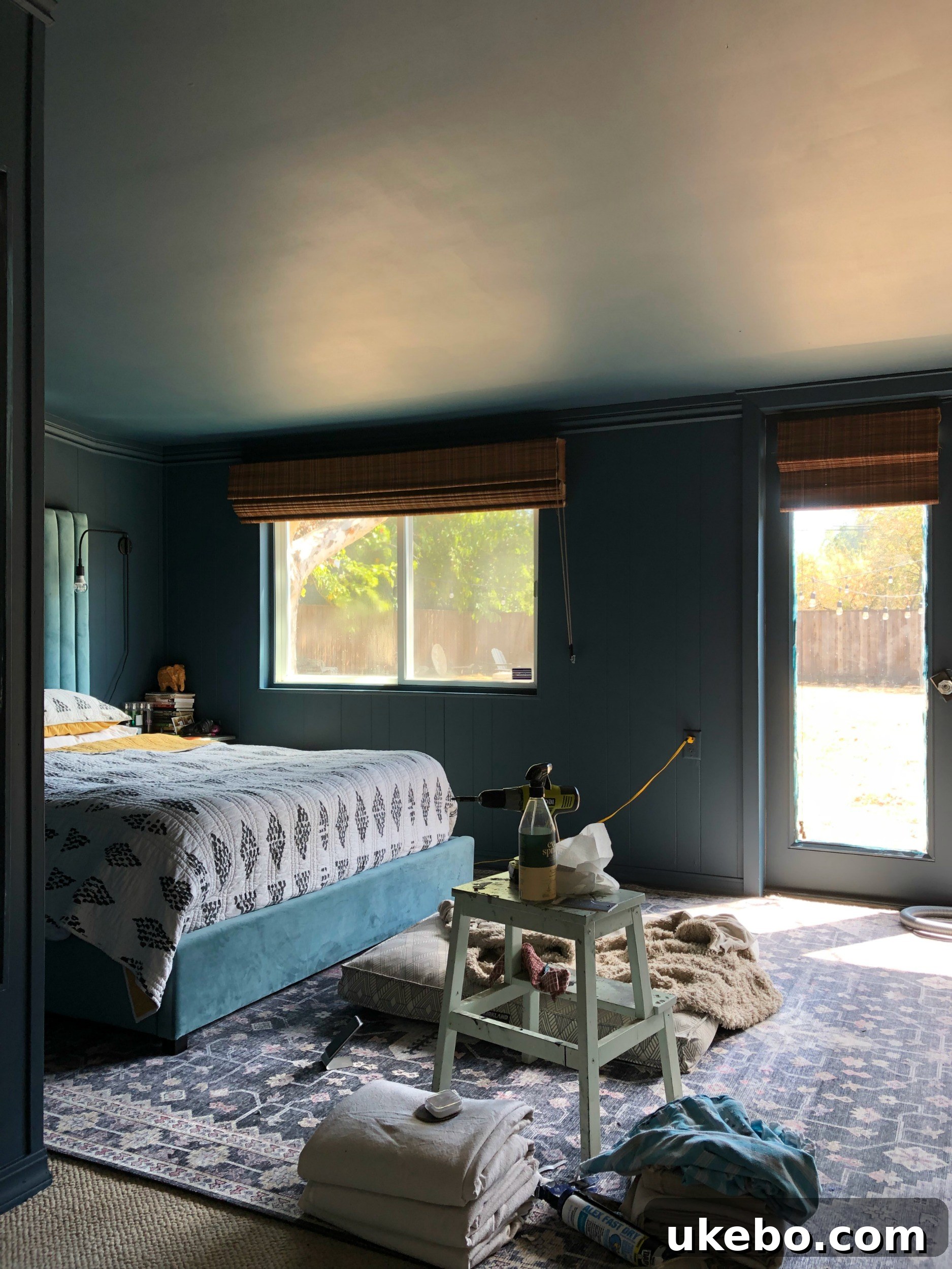 Primary bedroom painted in a moody blue before the major renovation.
