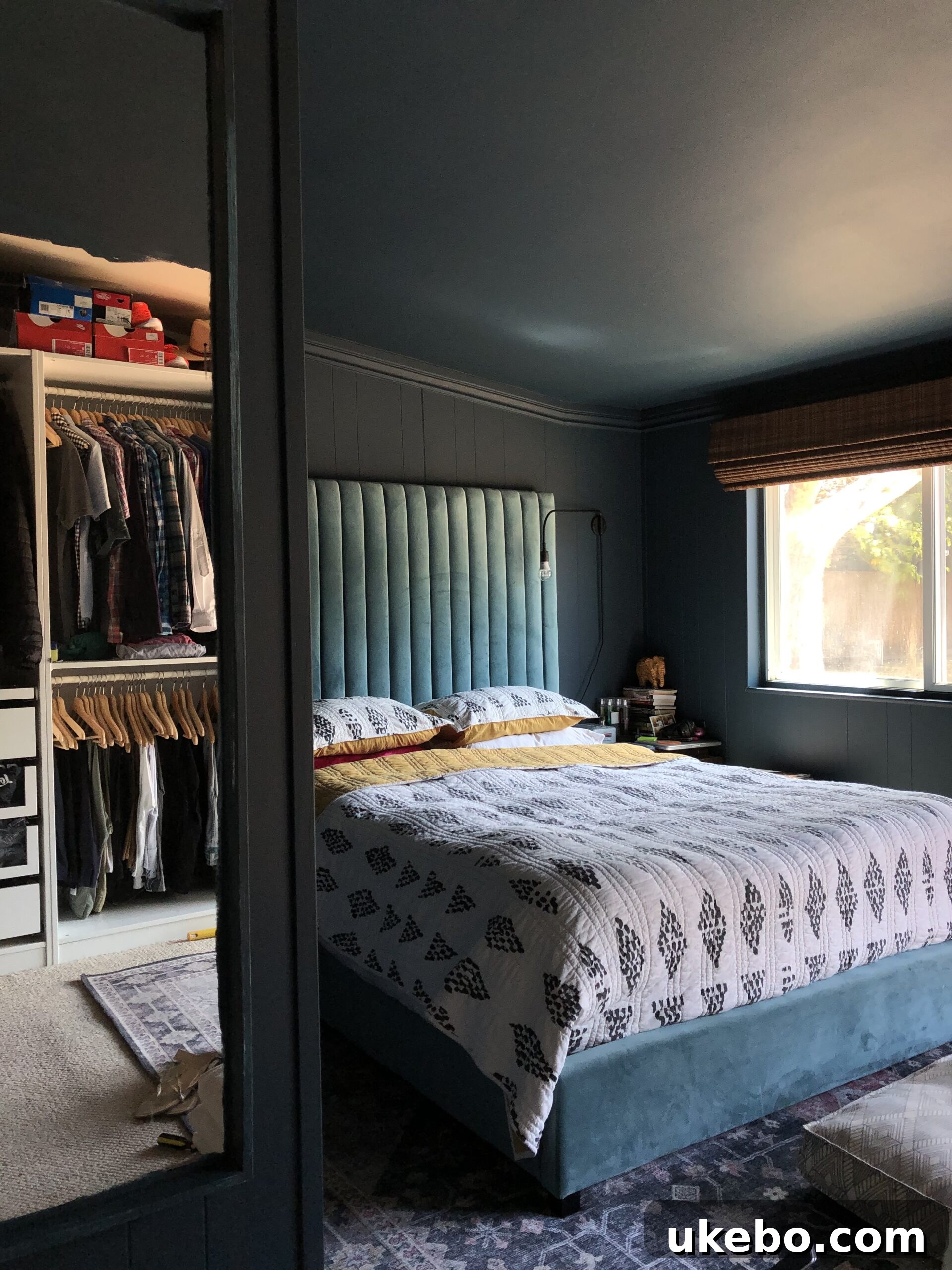 Another view of the primary bedroom with moody blue walls.