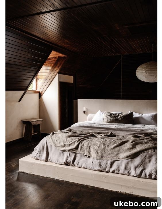 Minimalist space with a cozy bed and natural light.