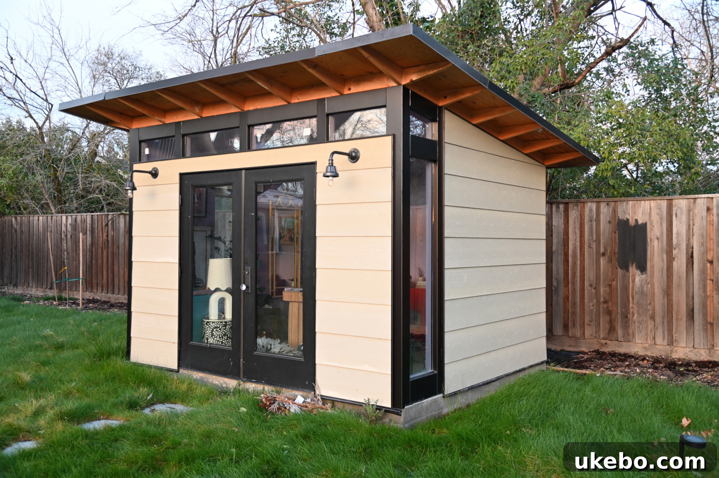 Another angle of the unpainted exterior studio, highlighting the original finish of the siding.