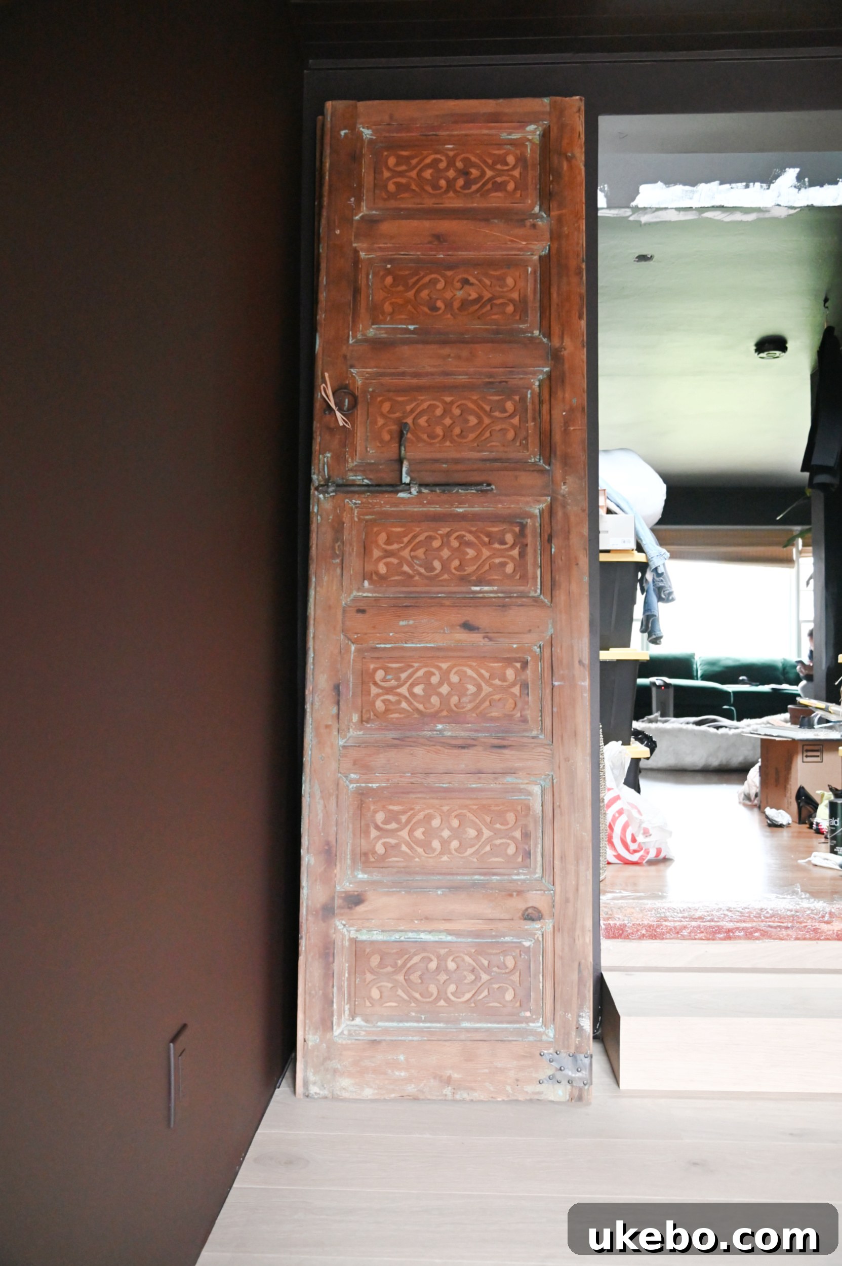 Ornate vintage Moroccan doors installed in the primary bedroom, adding a dramatic focal point and sense of history.