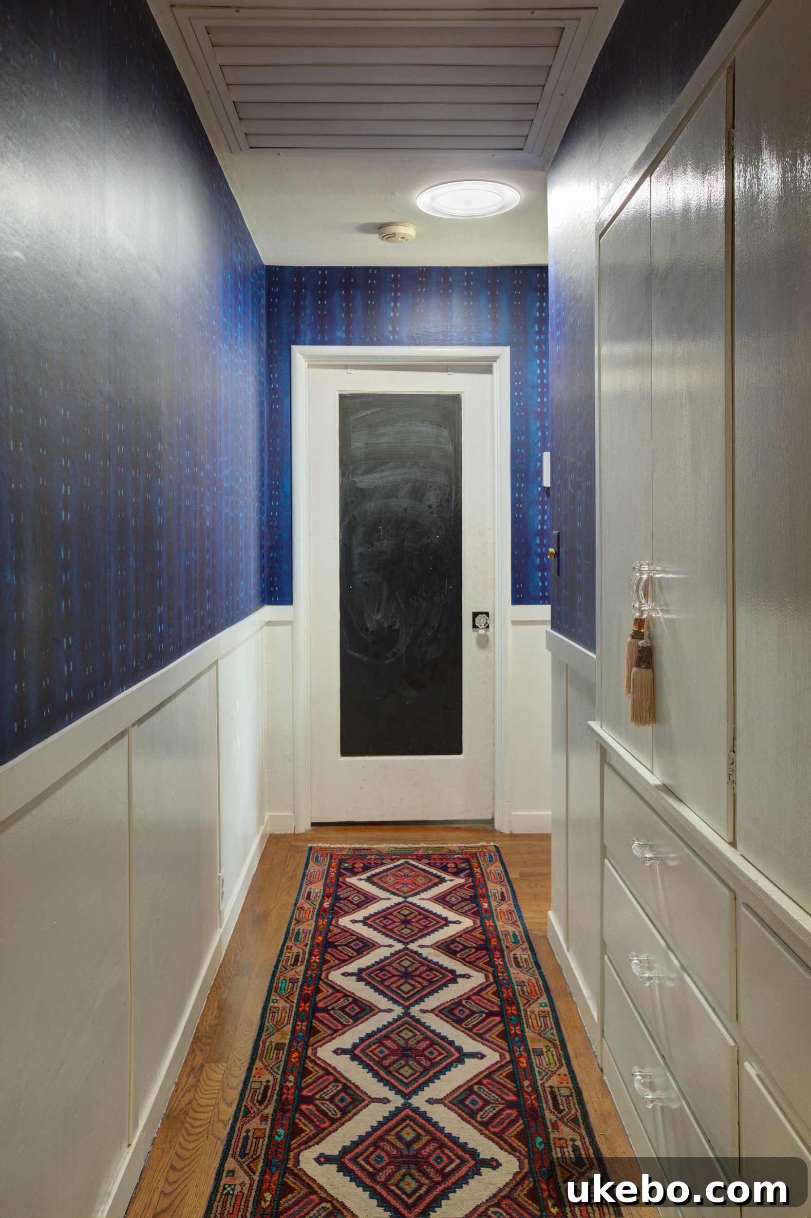 Bright hallway with arched entrance and wainscoting